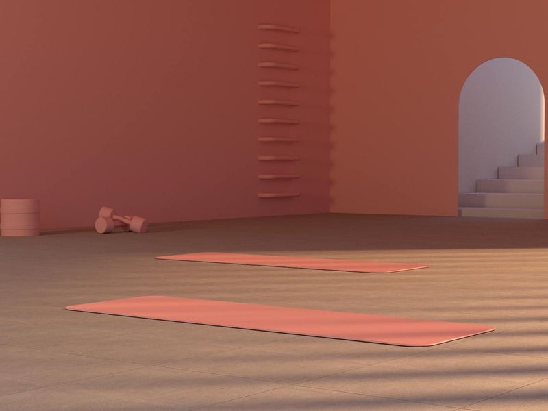 Gym equipment arranged neatly on a dark floor.